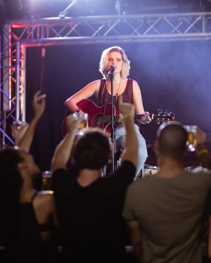 female-performer-singing-during-music-event.jpg